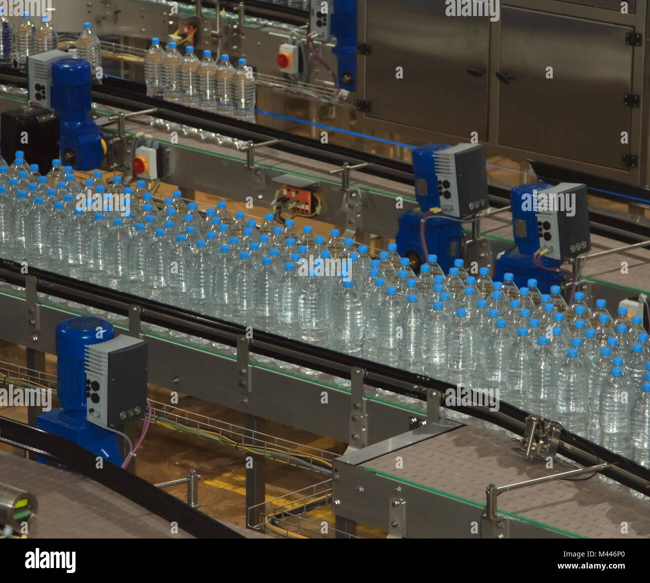 Plastic water bottles on conveyor and water bottling machine industry