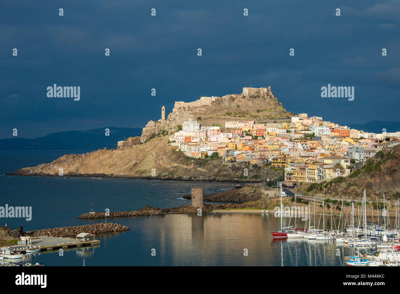 Dramatic light over the old town of Castelsardo with its boat harbour,Sardinia,Italy Stock Photo