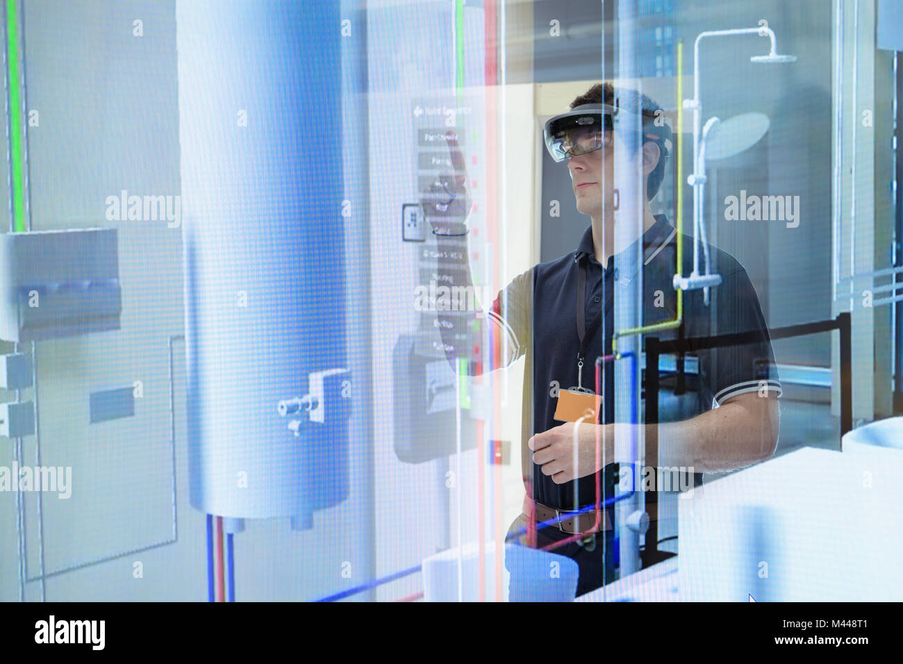 Engineer using augmented reality headset to 'see' utilities through walls in robotics research facility Stock Photo