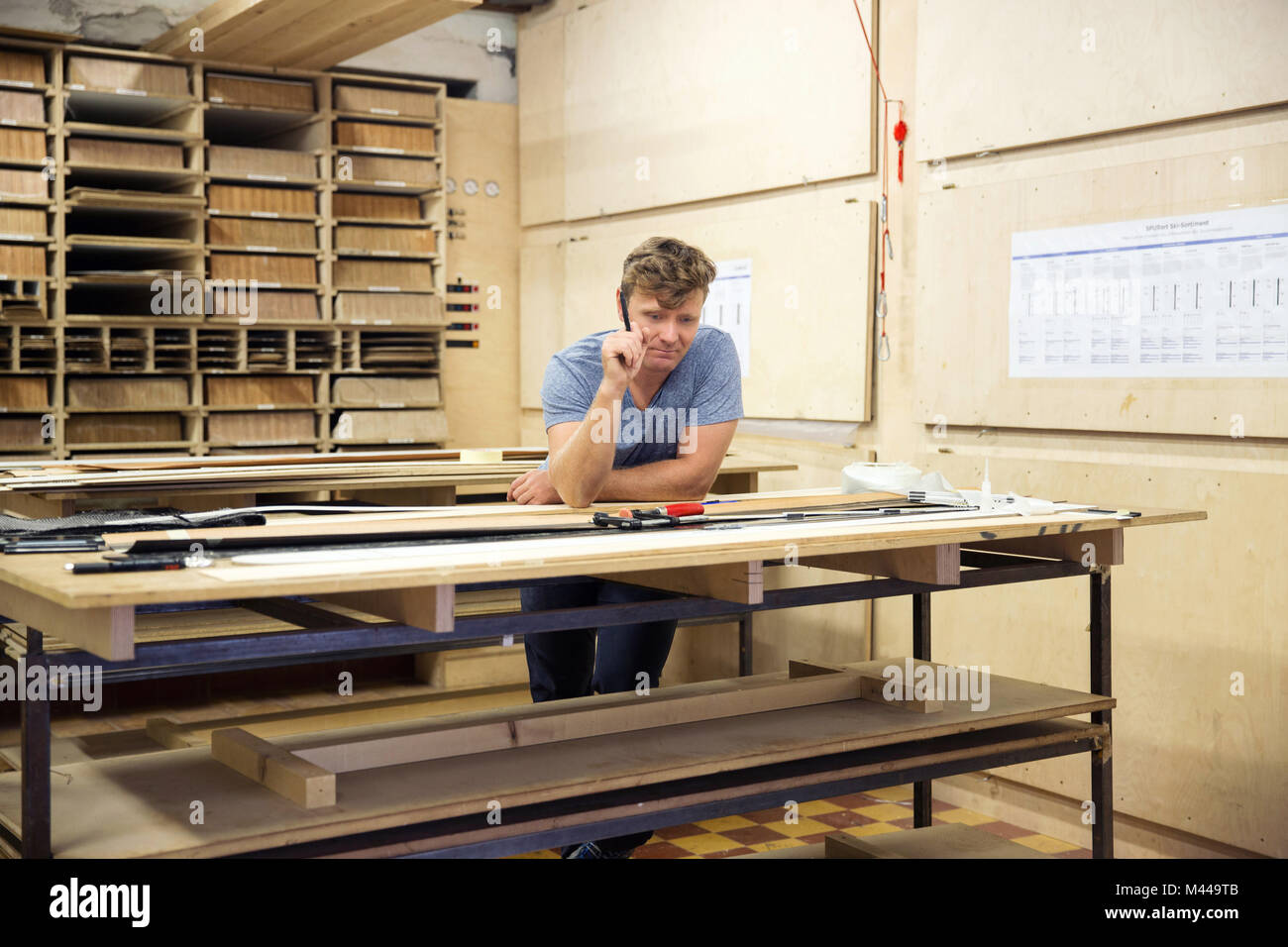 Man in workshop, making ski equipment, problem solving Stock Photo