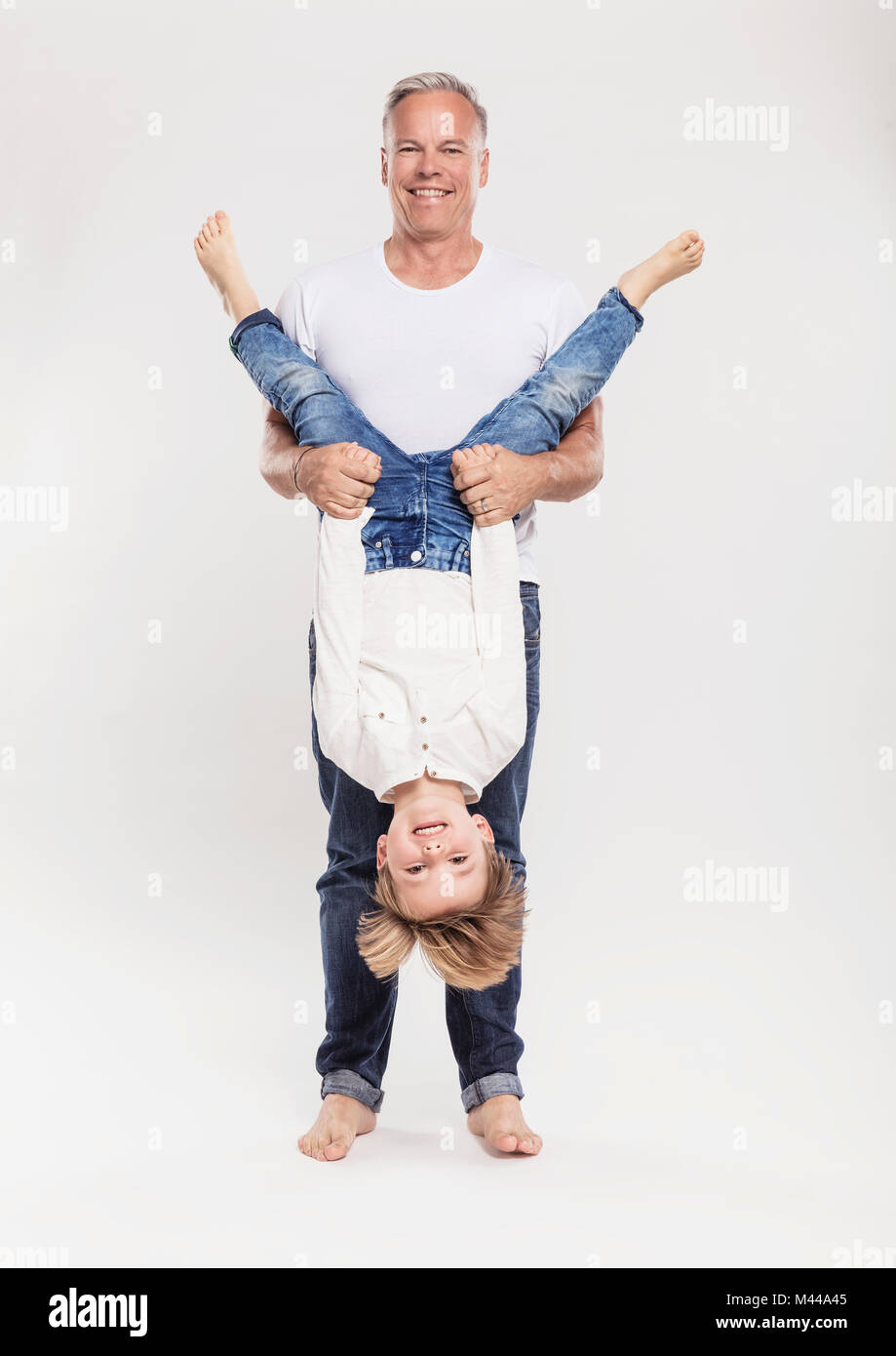 Child held upside down hires stock photography and images Alamy