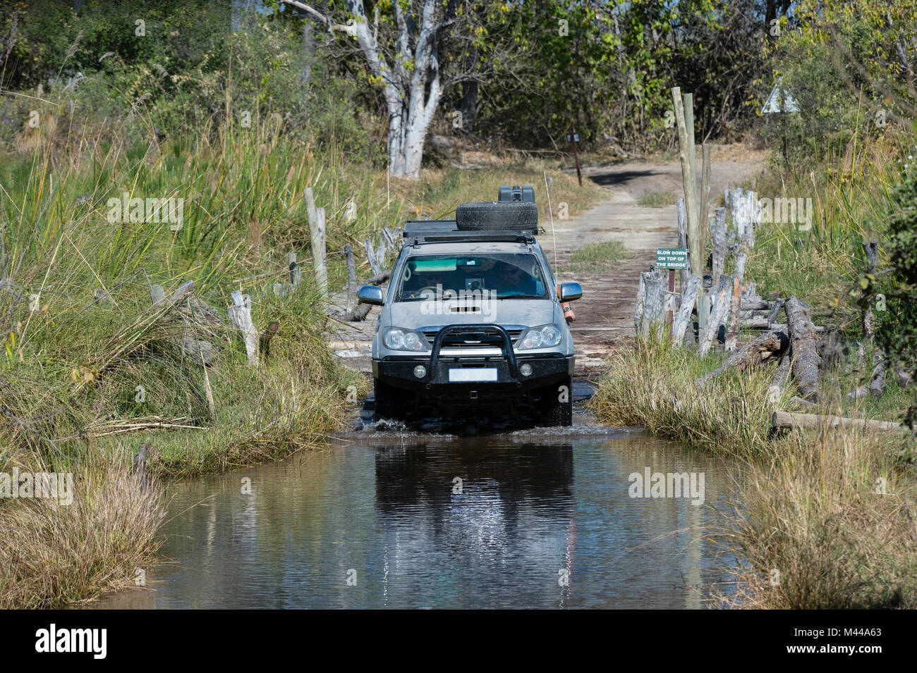 Off road vehicle crossing water in the Moremi Game Reserve, Okavango Delta, Botswana Stock Photo