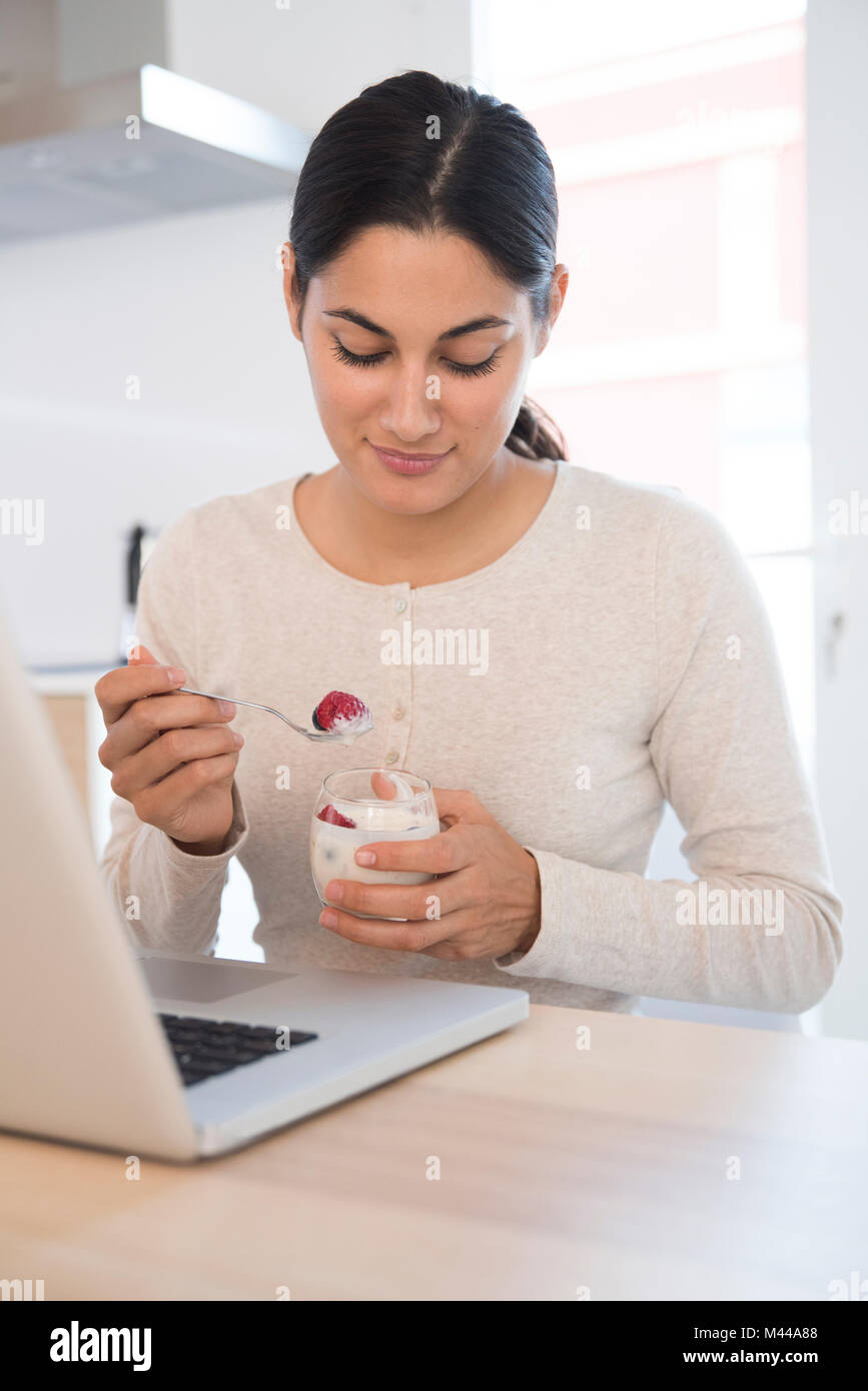 Woman eating fruits and yoghurt Stock Photo Alamy