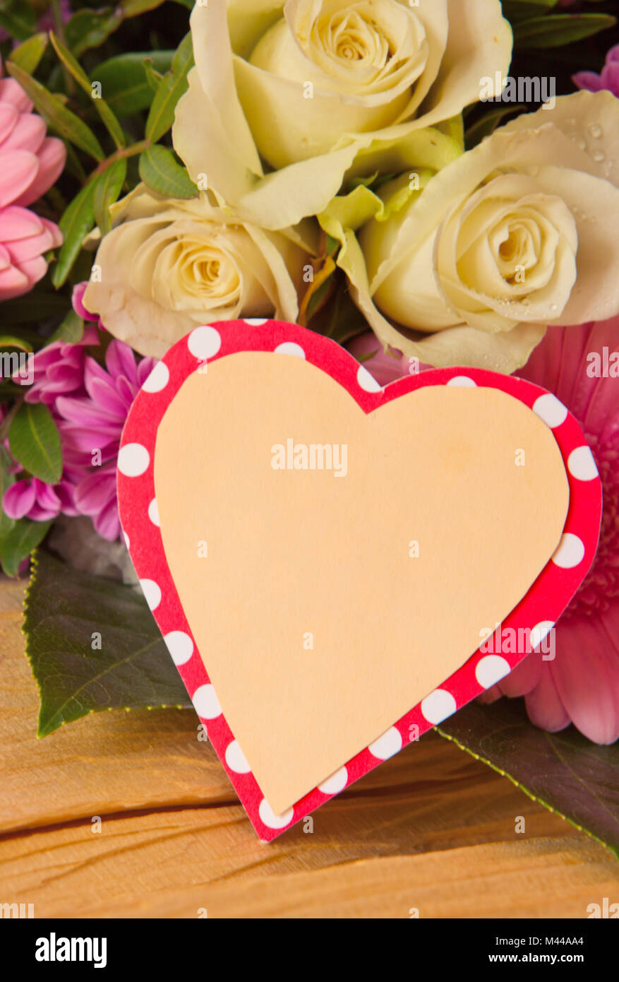 Colorful flowers bouquet  and heart shaped card. Stock Photo