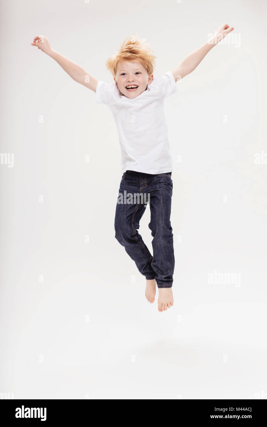 Portrait of boy leaping in air Stock Photo