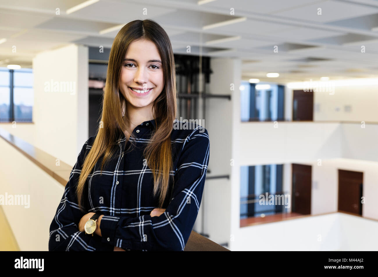 Portrait of young businesswoman in office atrium Stock Photo