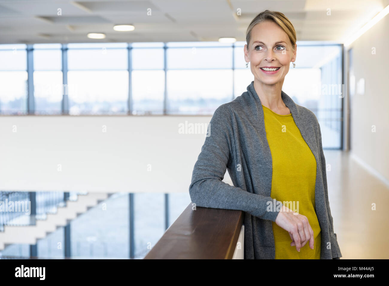 Confident mature businesswoman in office atrium Stock Photo