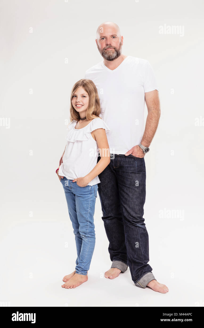 Studio portrait of mature man with daughter, full length Stock Photo