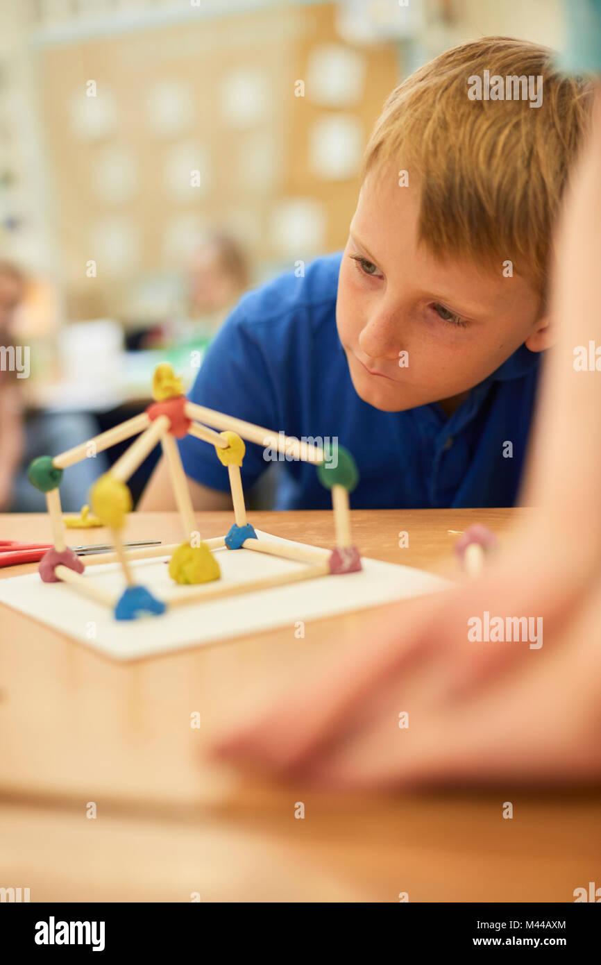 https://c8.alamy.com/comp/M44AXM/primary-schoolboy-looking-at-plastic-straw-model-on-classroom-desks-M44AXM.jpg