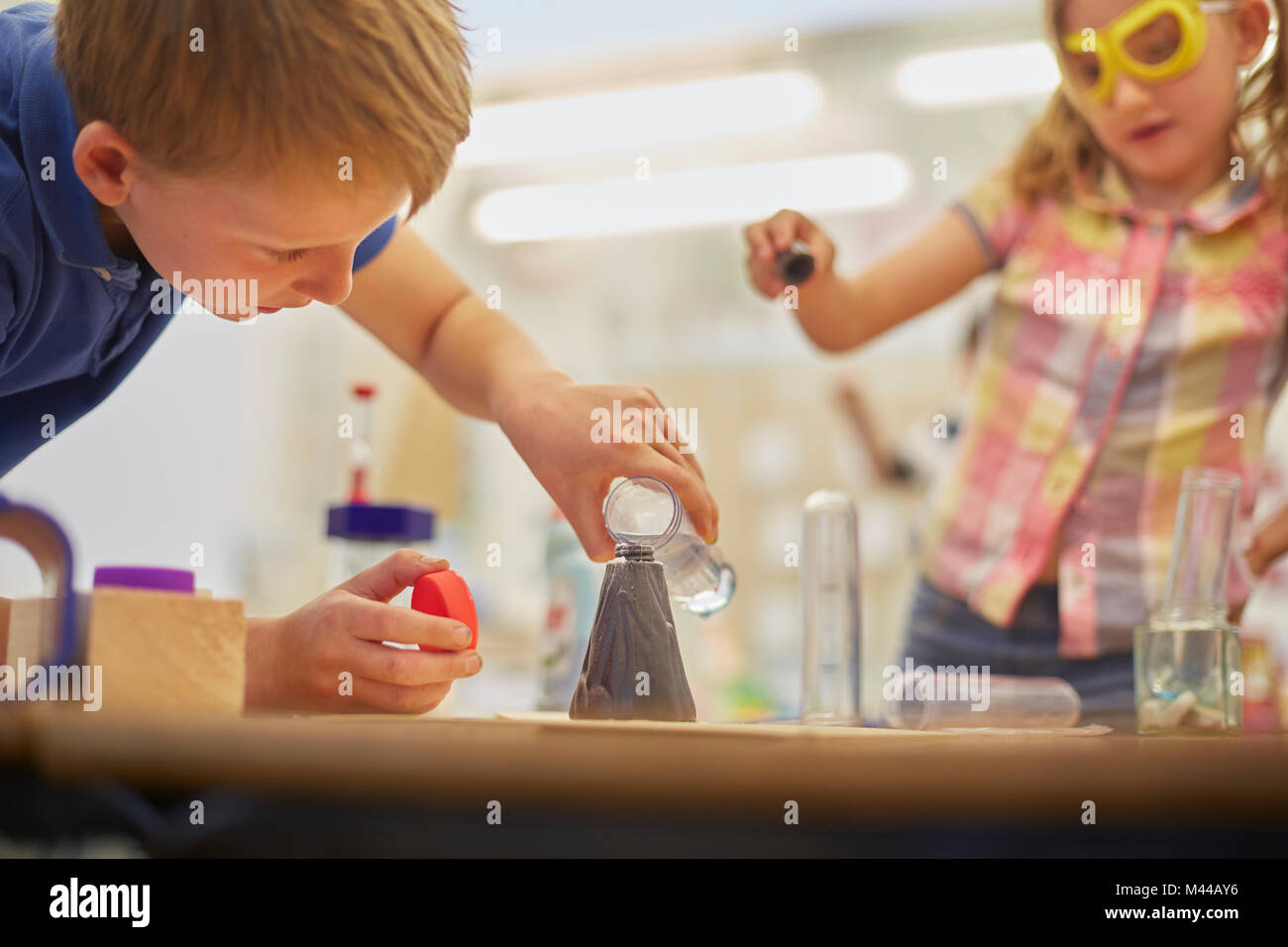 Primary schoolboy and girl doing test tube experiment in classroom Stock Photo