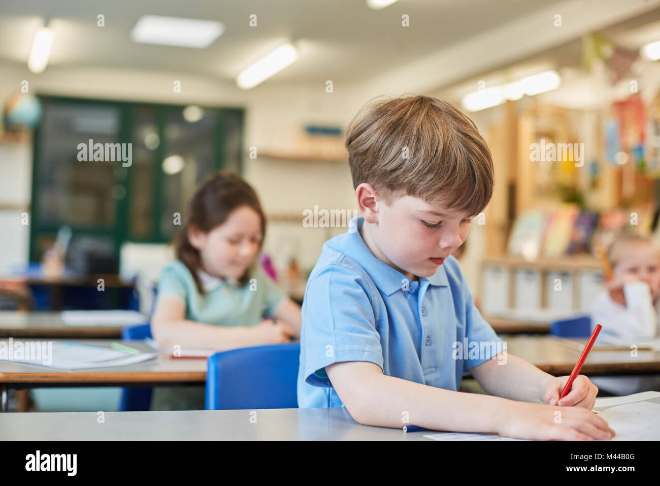 Schoolboy counting writing in classroom lesson at primary school Stock Photo