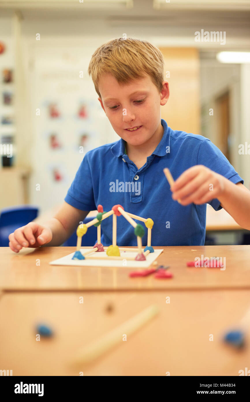 Schoolboy making ball and stick model in classroom at primary school Stock Photo