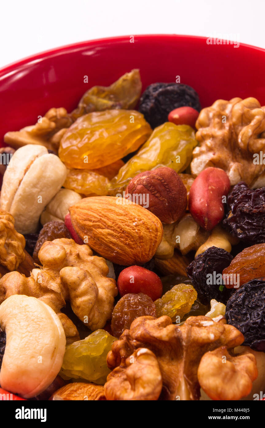 various different mixed nuts and raisins on white background Stock