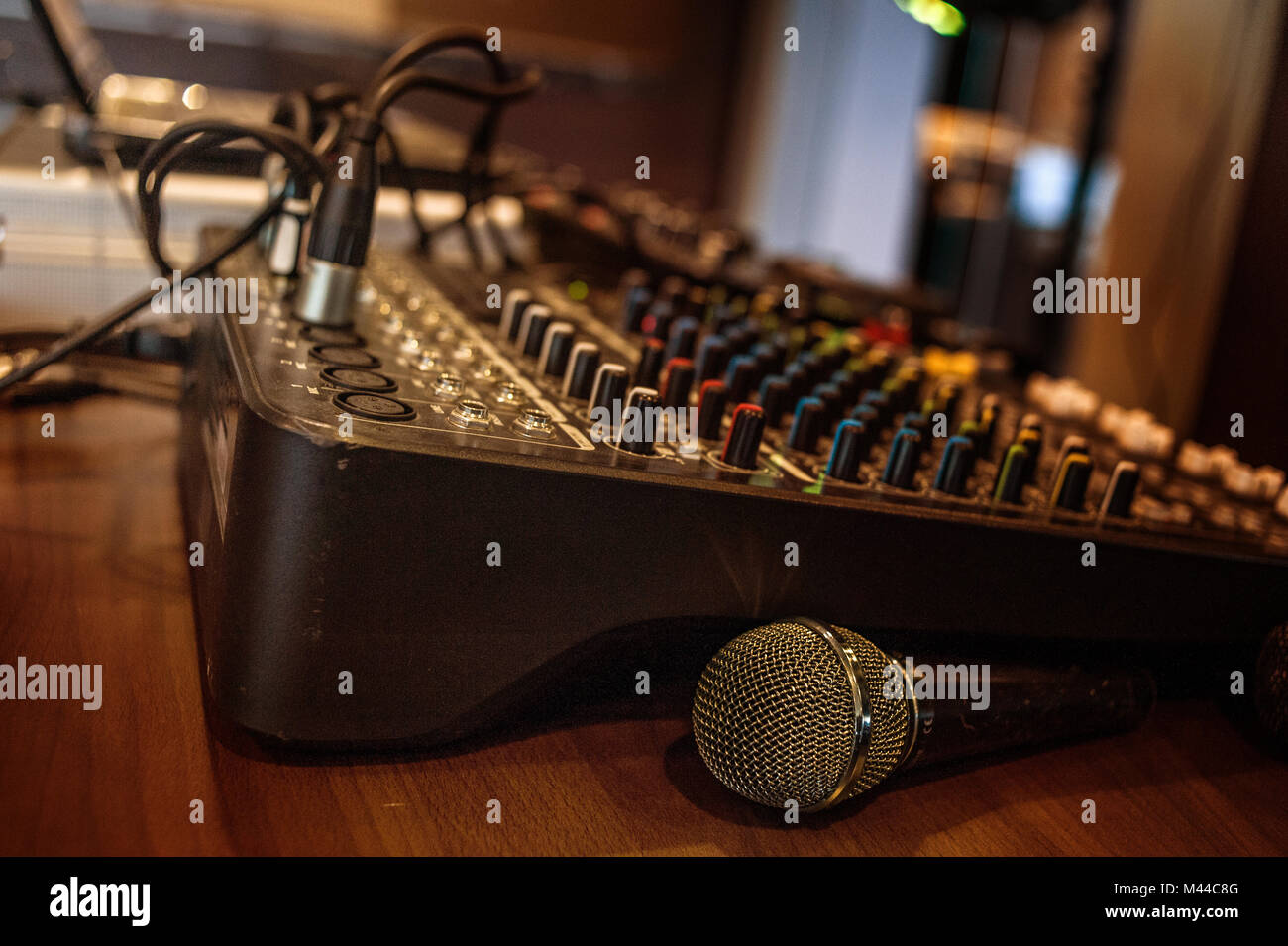Detail of a sound mixer with a microphone and a laptop with a club