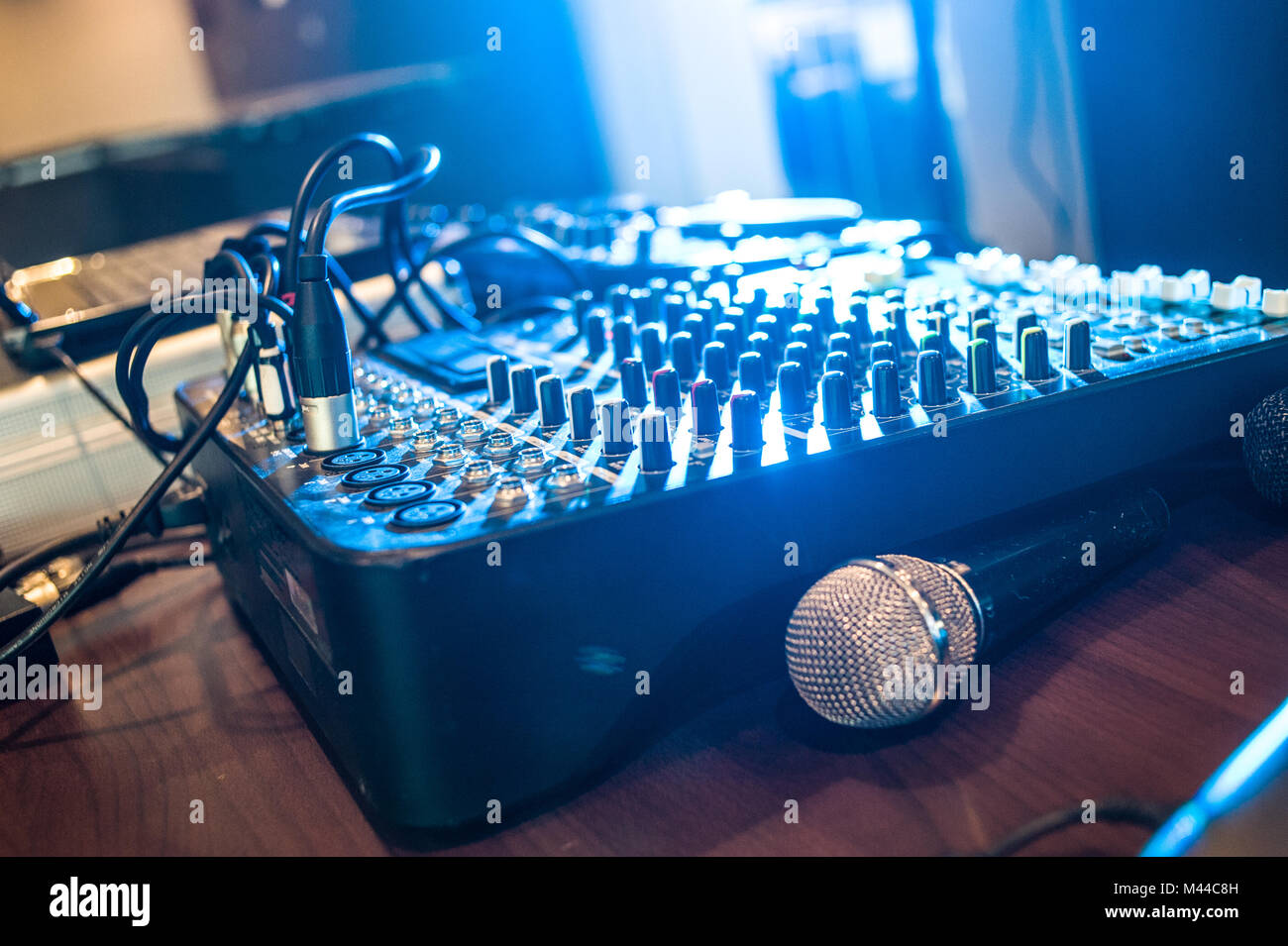 Detail of a sound mixer with a microphone and a laptop with a club