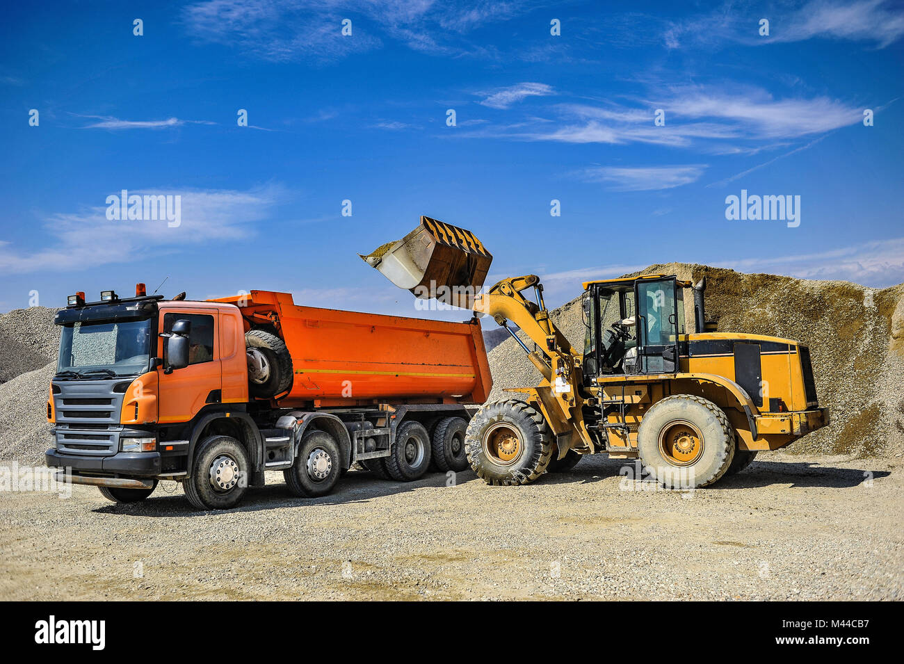 Gravel pit working site with trucks on a sunny day Stock Photo - Alamy