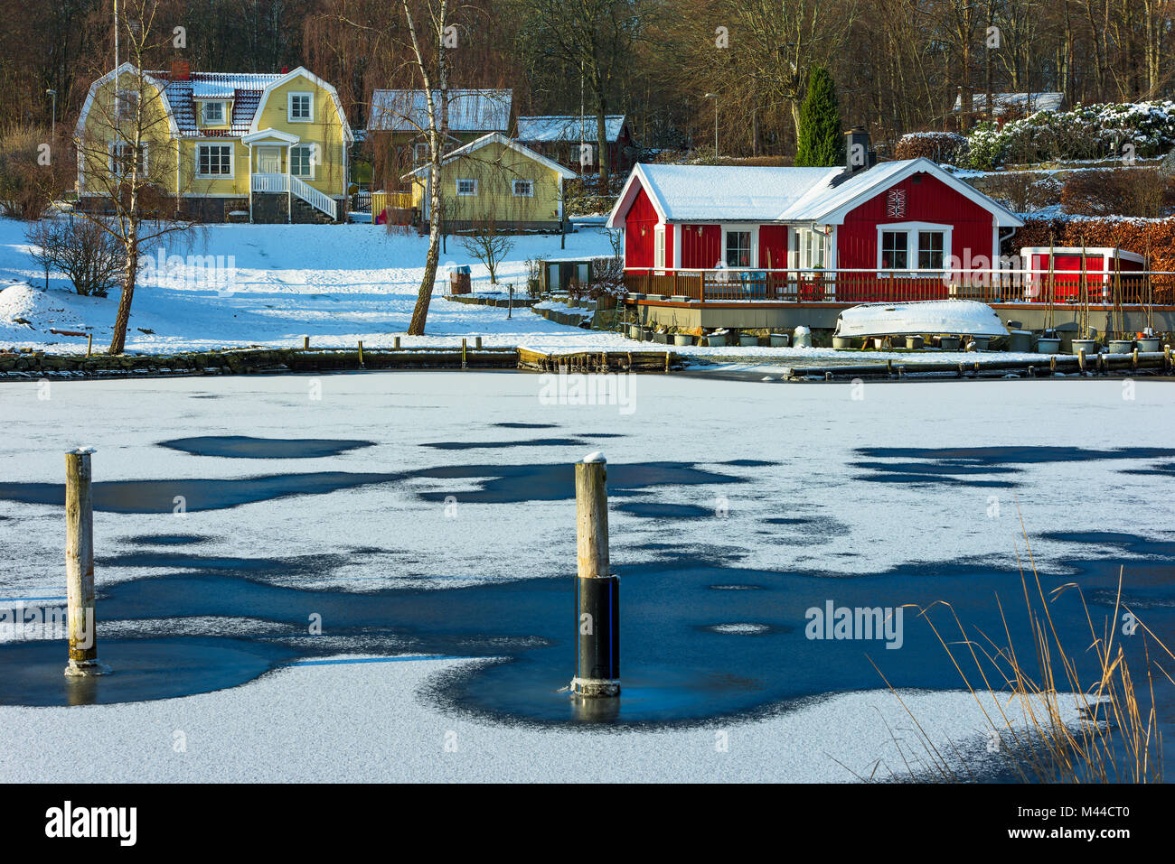 Bokevik, Sweden - February 7, 2018: Documentary of everyday life and environment. Small fishing village in winter with frozen sea and snow on the grou Stock Photo