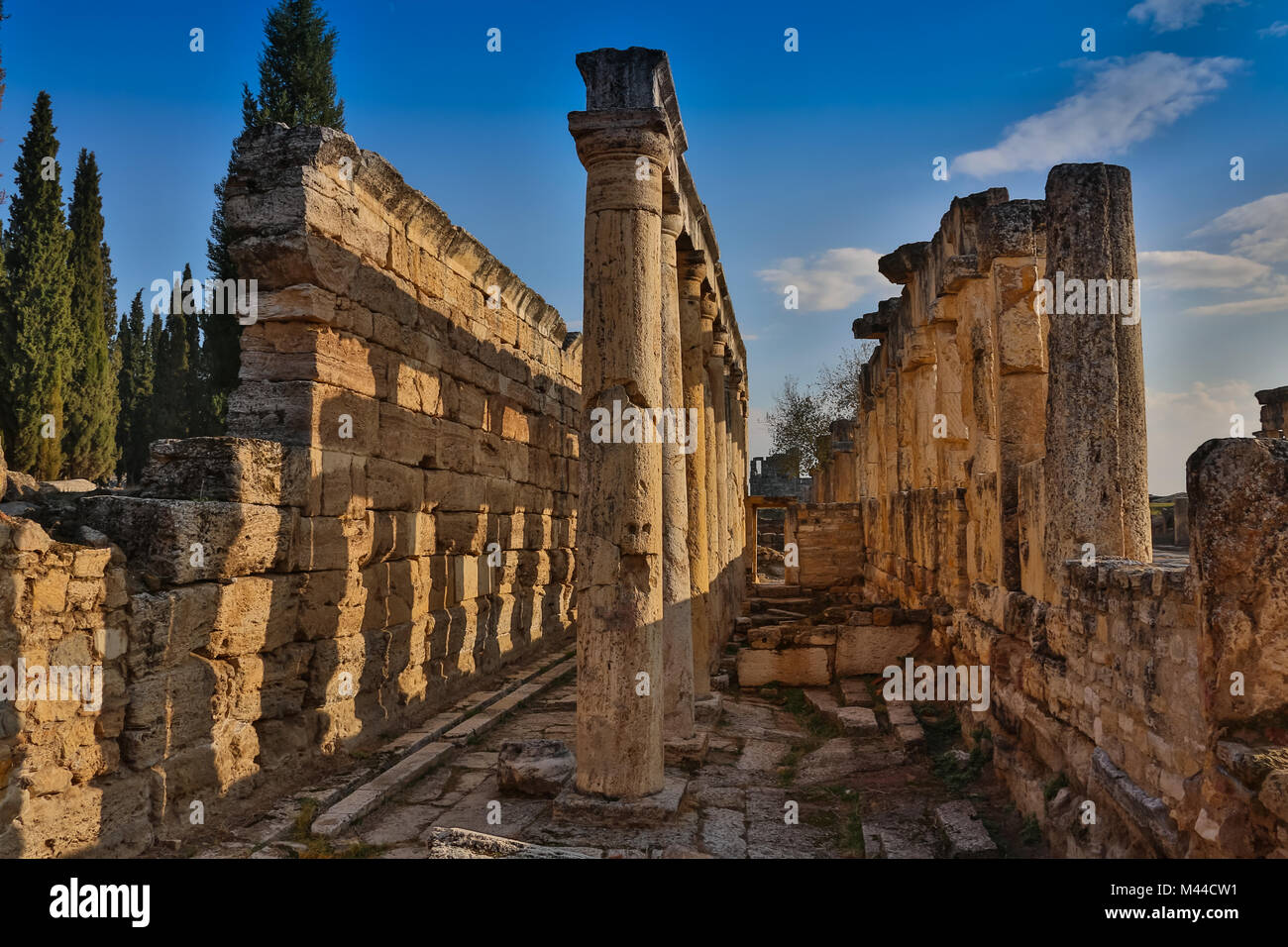 Ruins of Appollo temple with fortress at back in ancient Corinth, Peloponnese, Greece Stock Photo