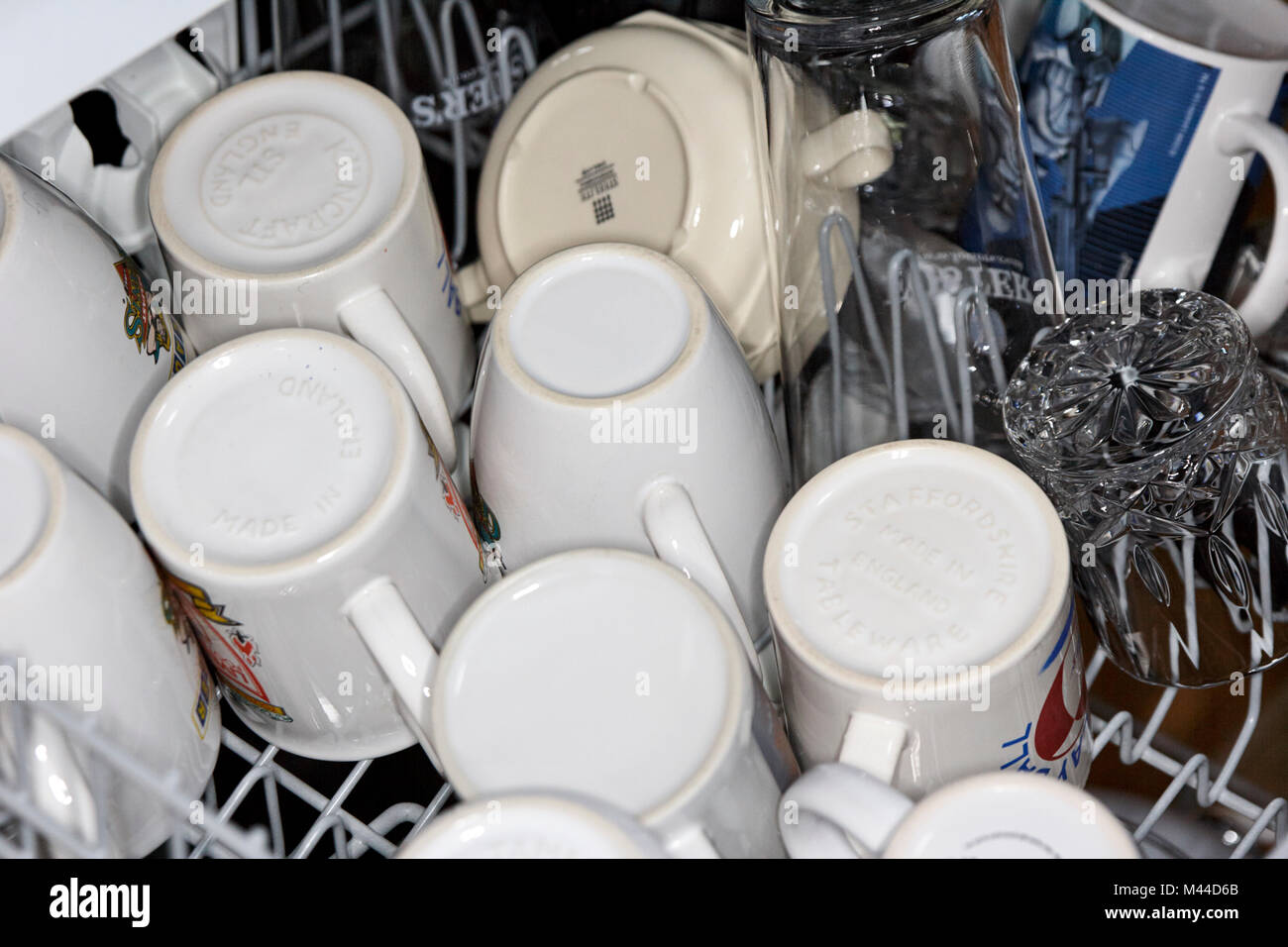 freshly washed and dried cups and glasses in a dishwasher Stock Photo