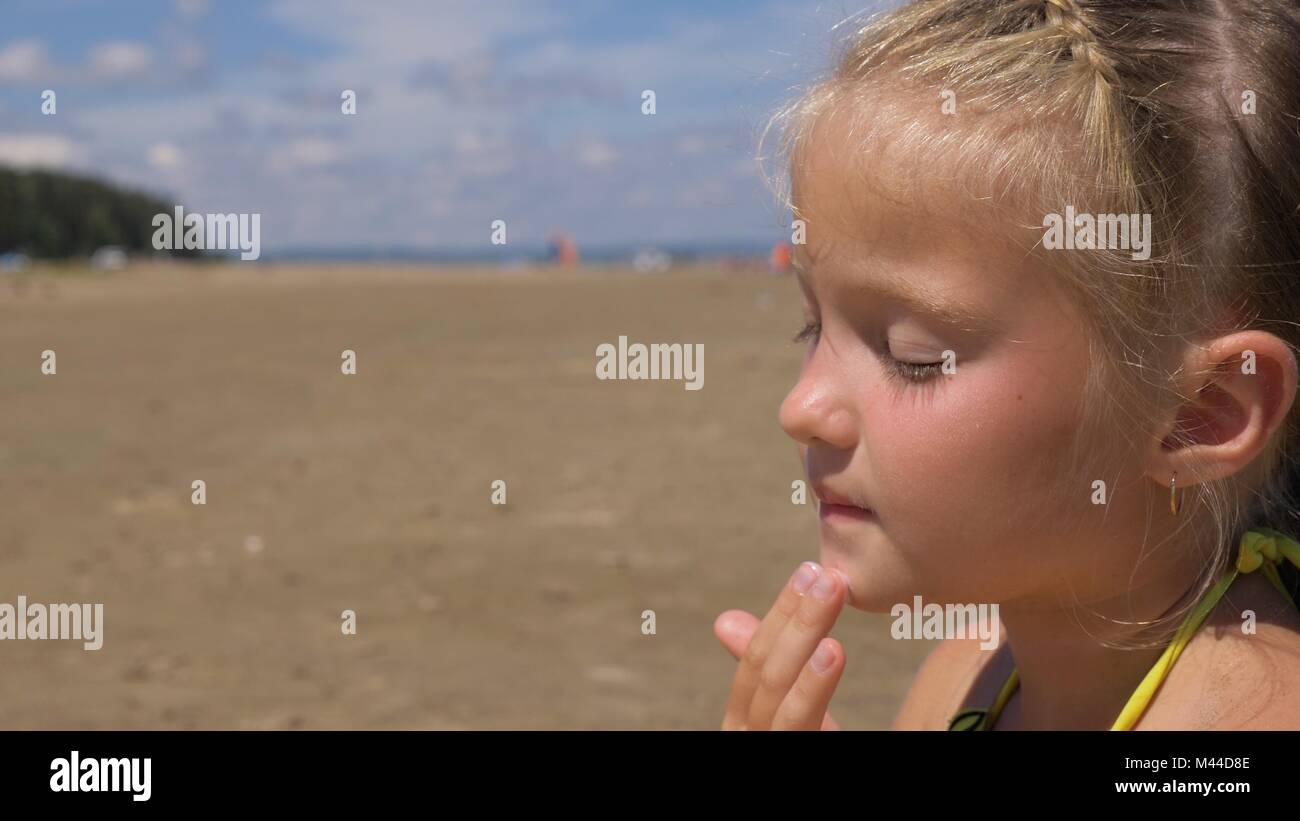 Apply sunscreen to face and body Stock Photo Alamy