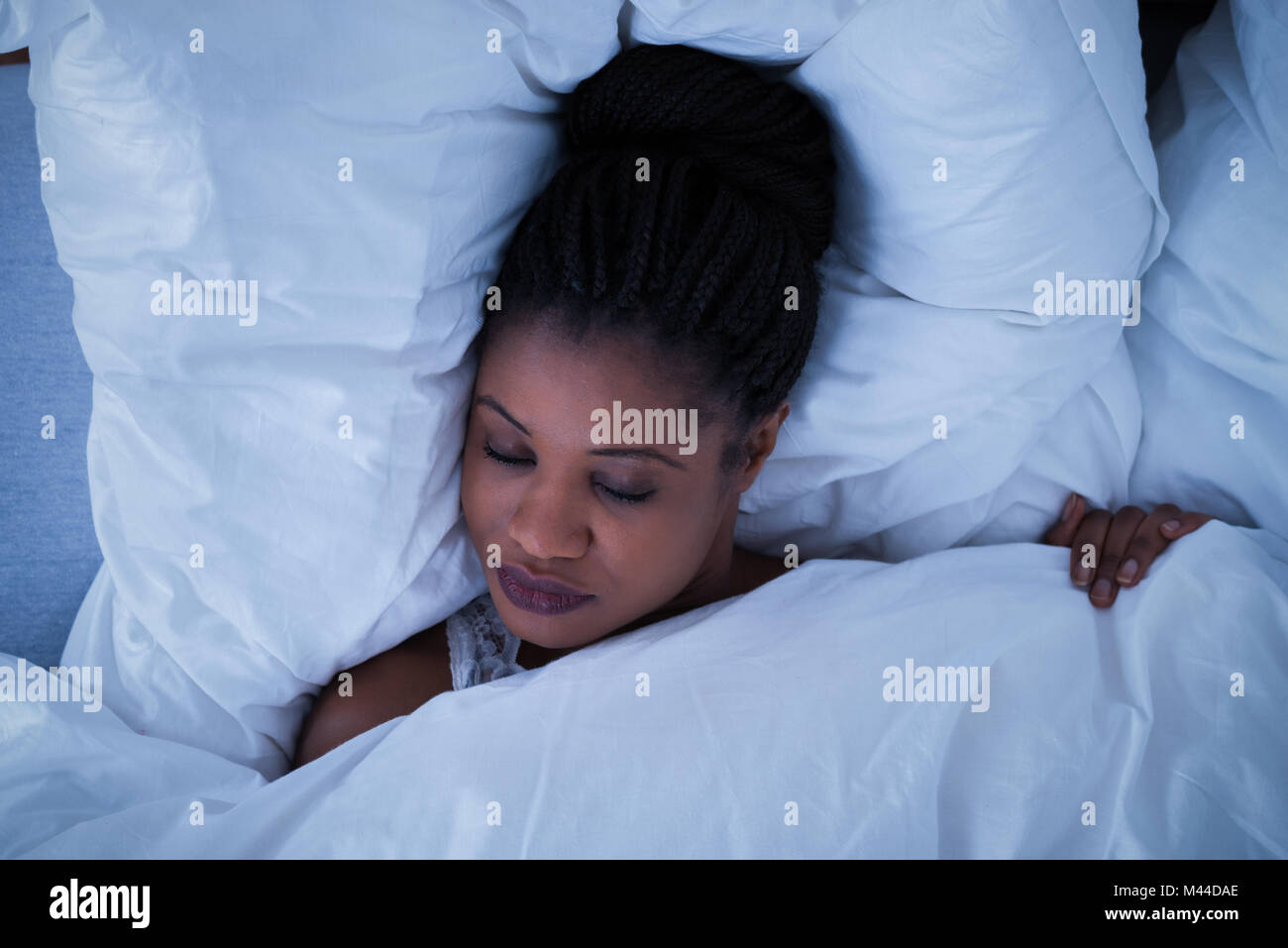 Elevated View Of A Young Woman Sleeping On Bed Stock Photo