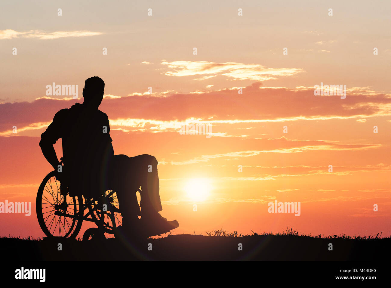 Silhouette Of A Person Sitting On Wheelchair Against Dramatic Sky At ...