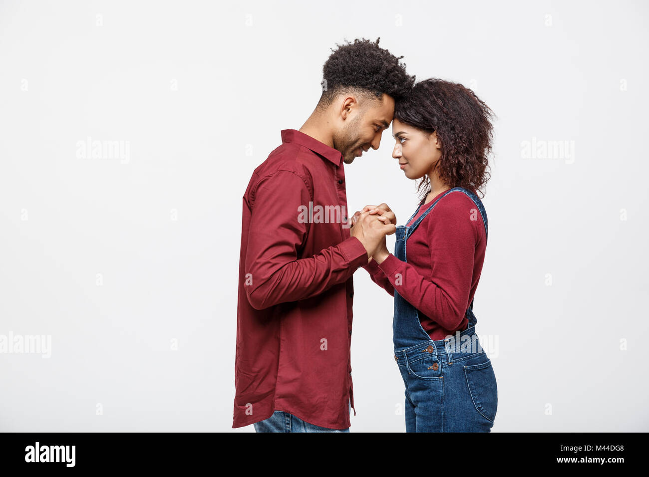 Side view of beautiful African American young couple in classic shirts ...