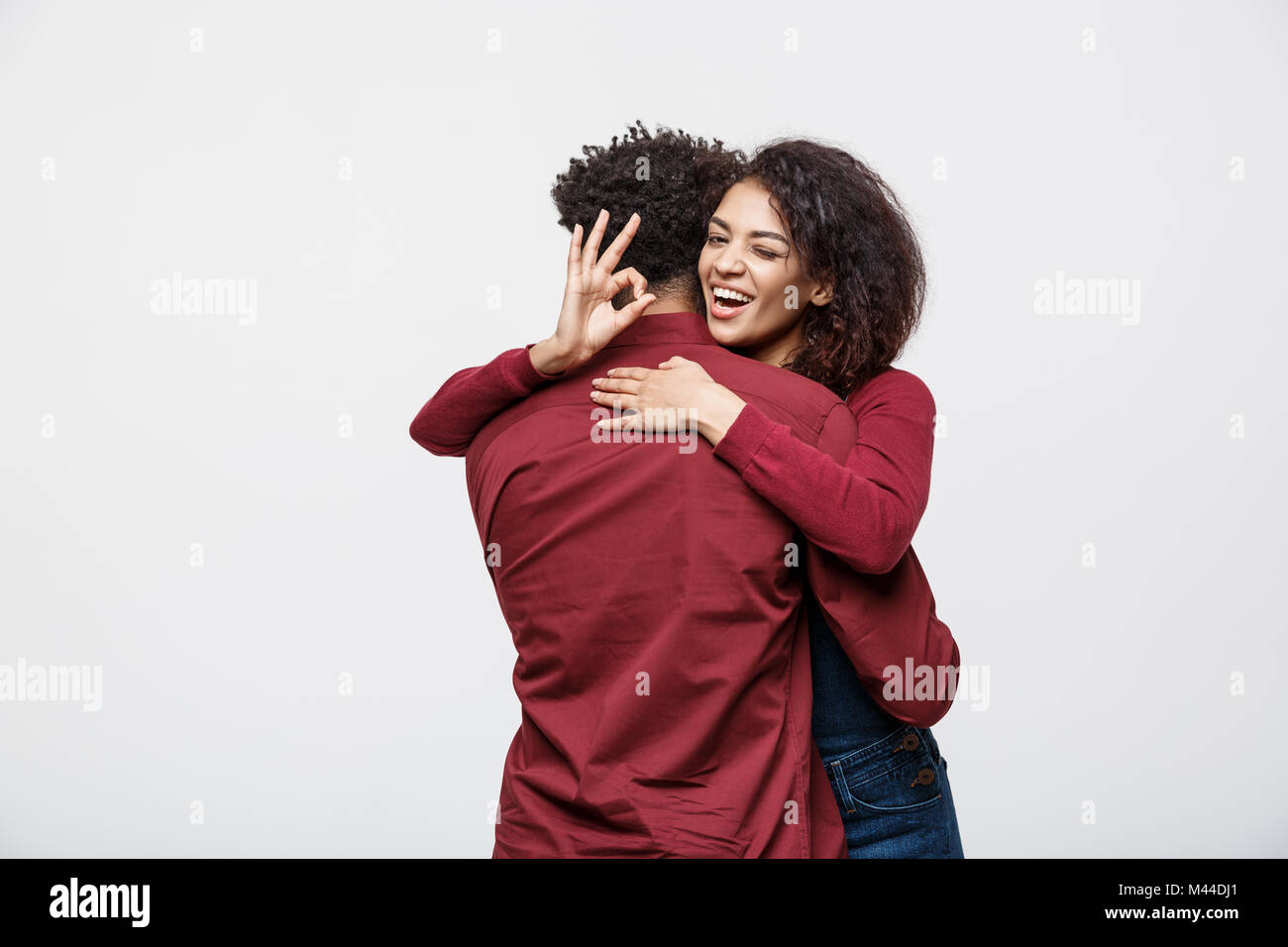 Portrait of a cheerful young african couple standing together and ...