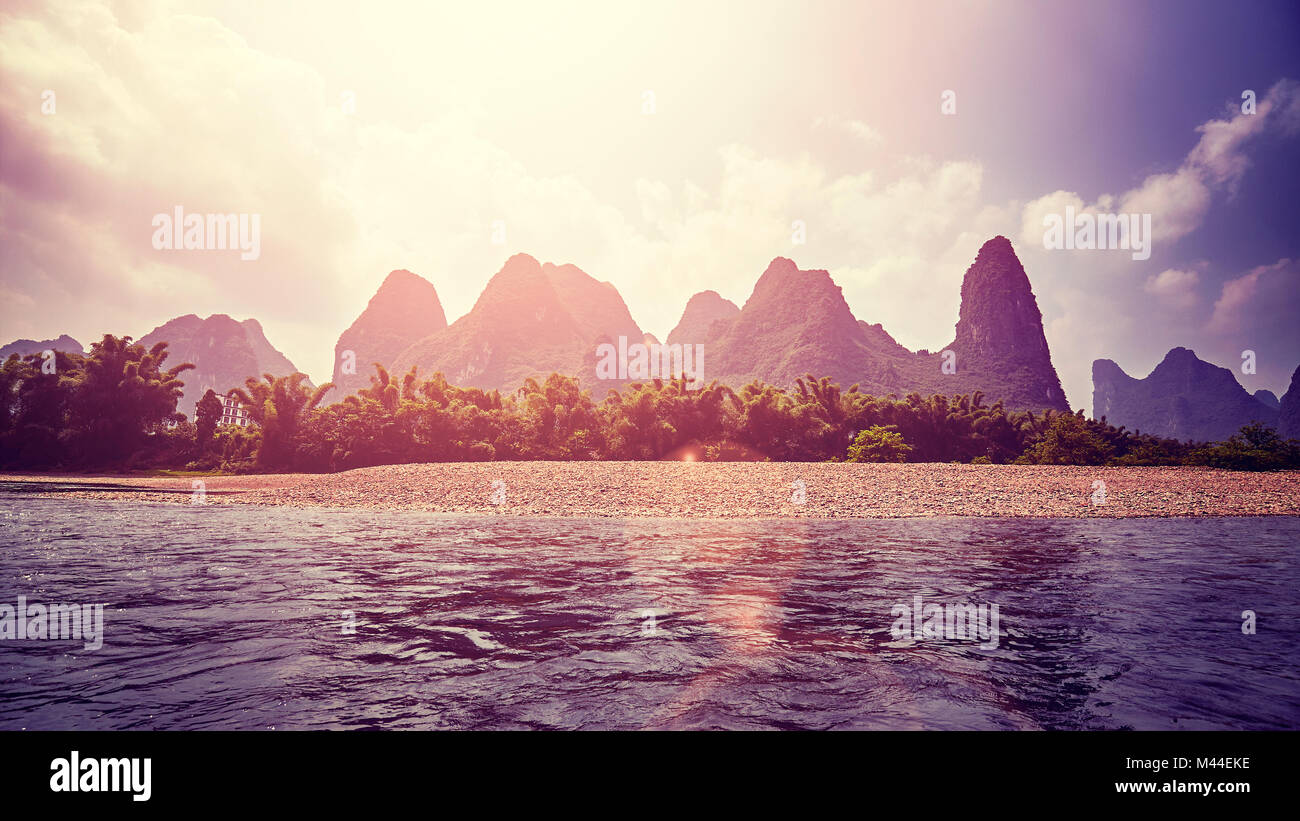 Sunset over Li River (Li Jiang), color toned picture with lens flare, China. Stock Photo