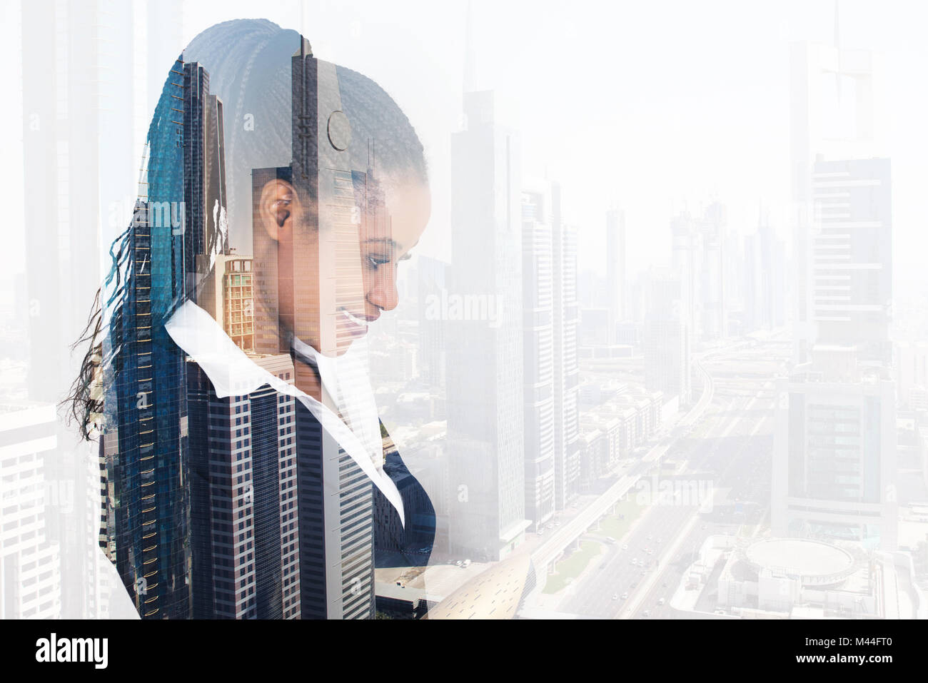 Digital composite image of young businesswoman smiling over city background Stock Photo