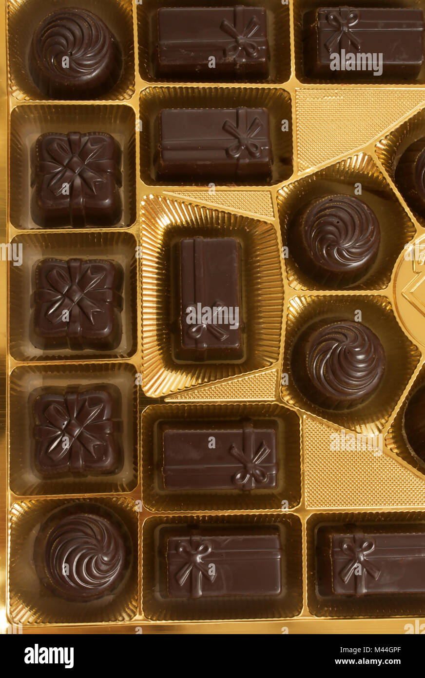 Box of chocolates inside. Dark chocolate in gold foil Stock Photo Alamy