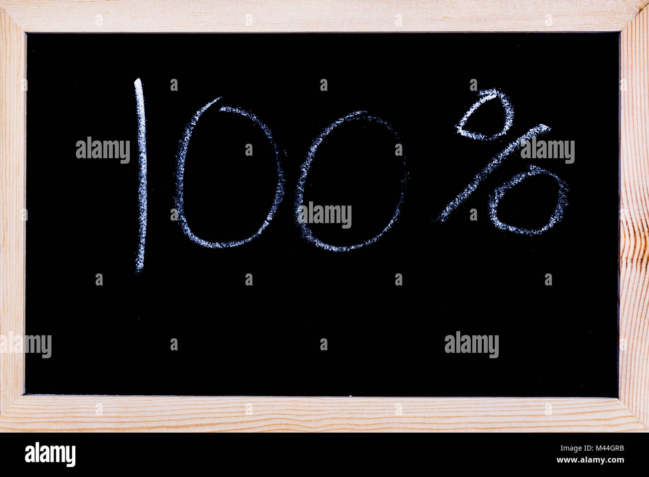 Blackboard with 100% written on it Stock Photo