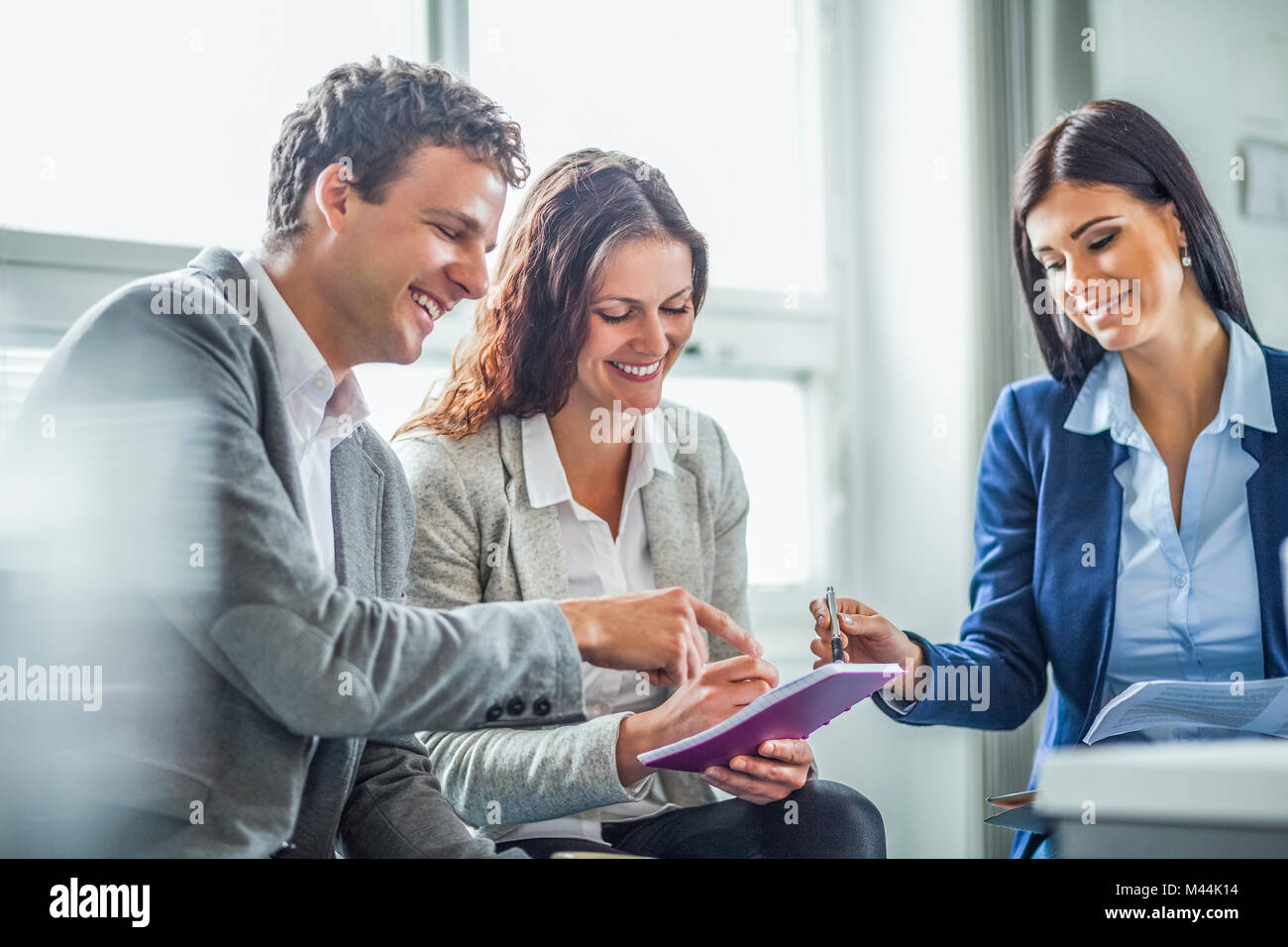 Smiling business people discussing in office Stock Photo - Alamy