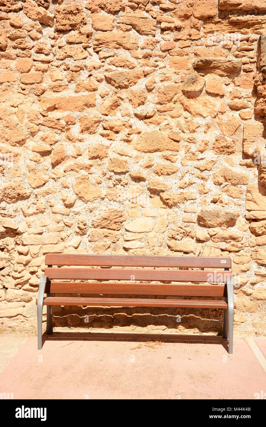 bench infront of old wall Stock Photo