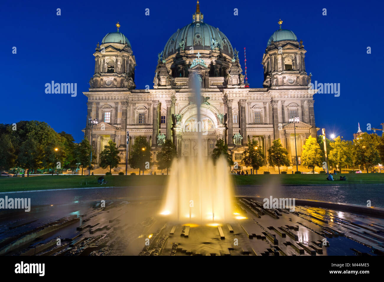 The Berlin Dom and a waterspout fountain at dawn Stock Photo