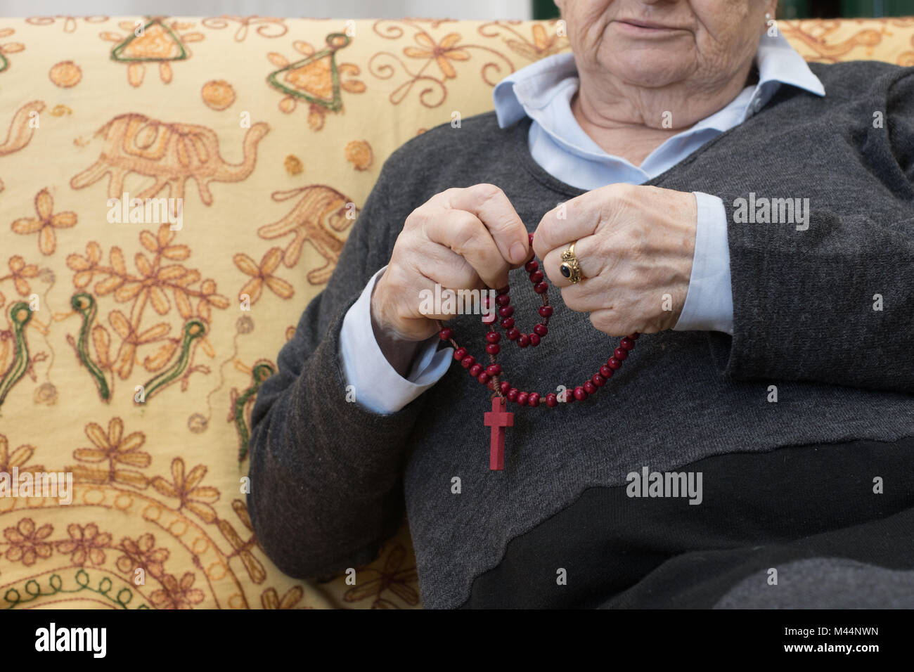 Elderly woman hands praying say the rosary, christianity religion lifestyle close up Stock Photo