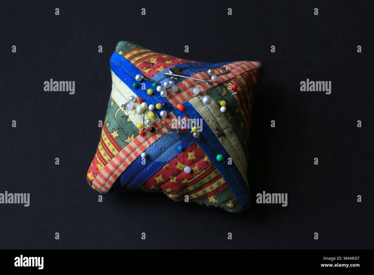 Colourful pin cushion with coloured pins Stock Photo Alamy