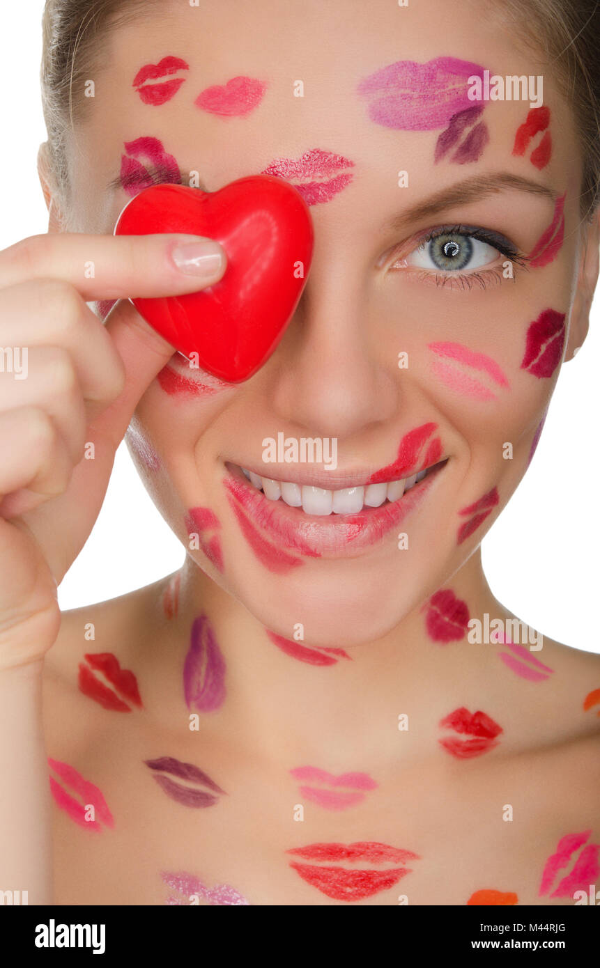 beautiful woman with kisses on face holding heart eyes Stock Photo