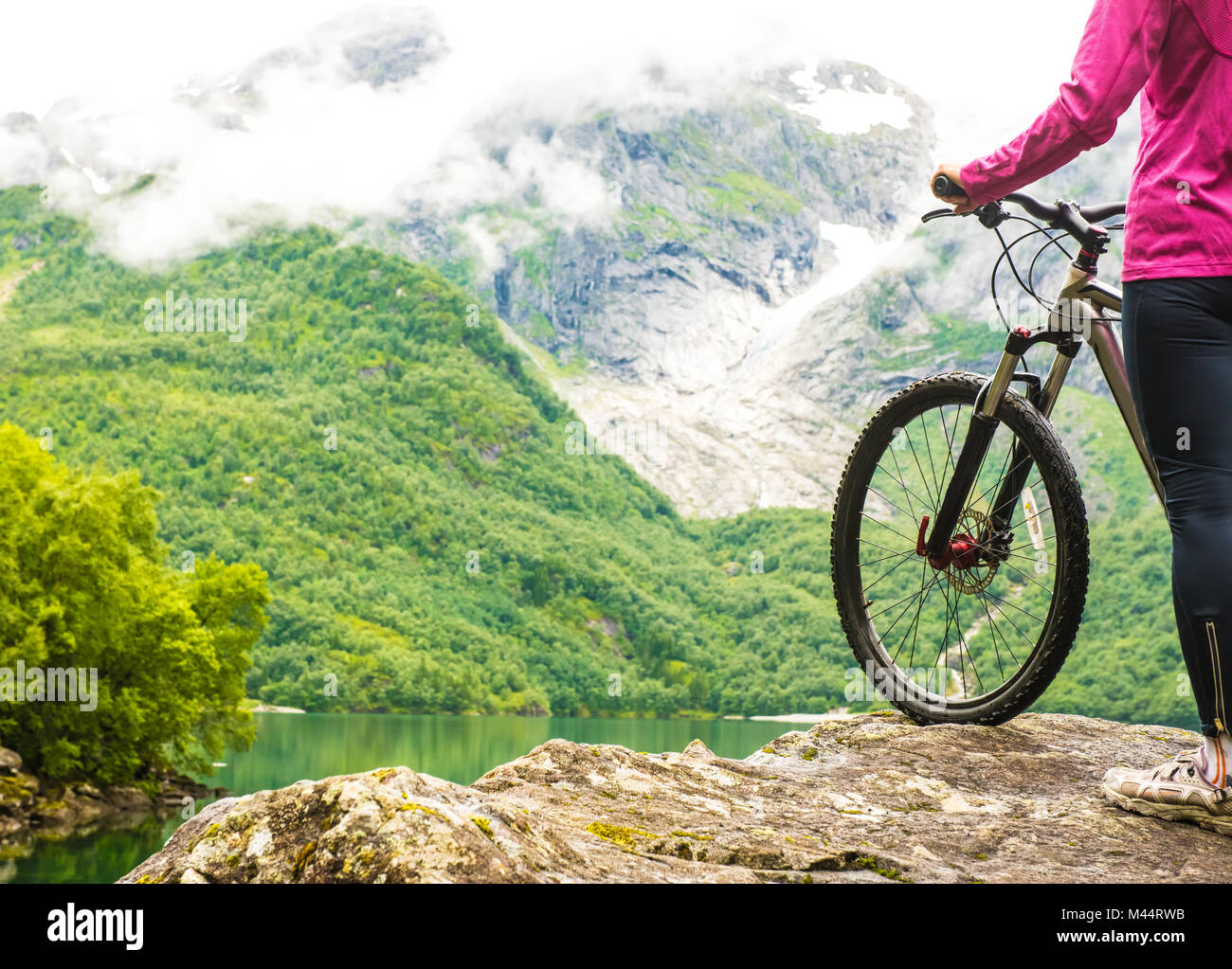 Biking in Norway against picturesque landscape Stock Photo