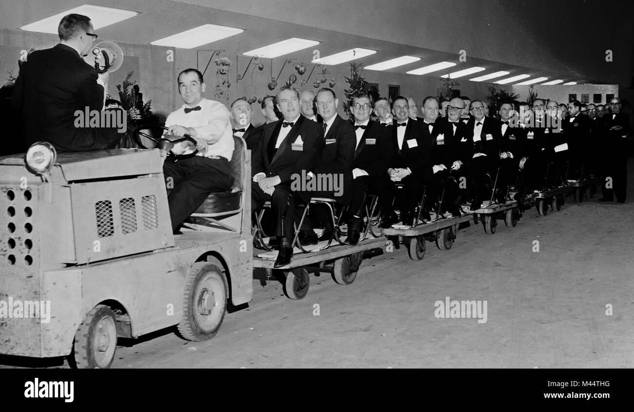 Men on a tour train, ca. 1955. Stock Photo