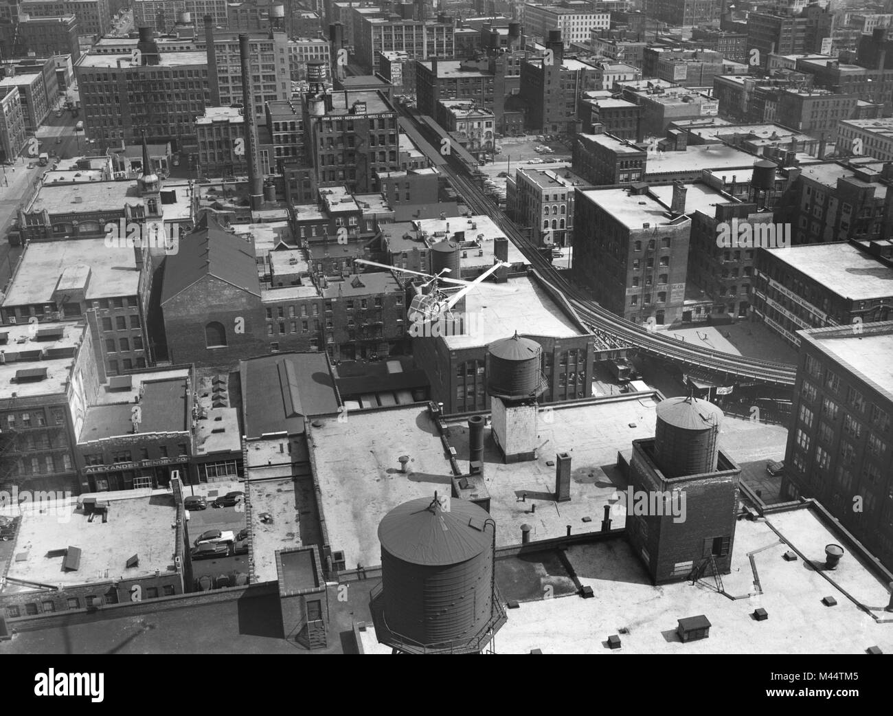 Small helicopter flies over the near north side of Chicago, ca. 1960. Stock Photo