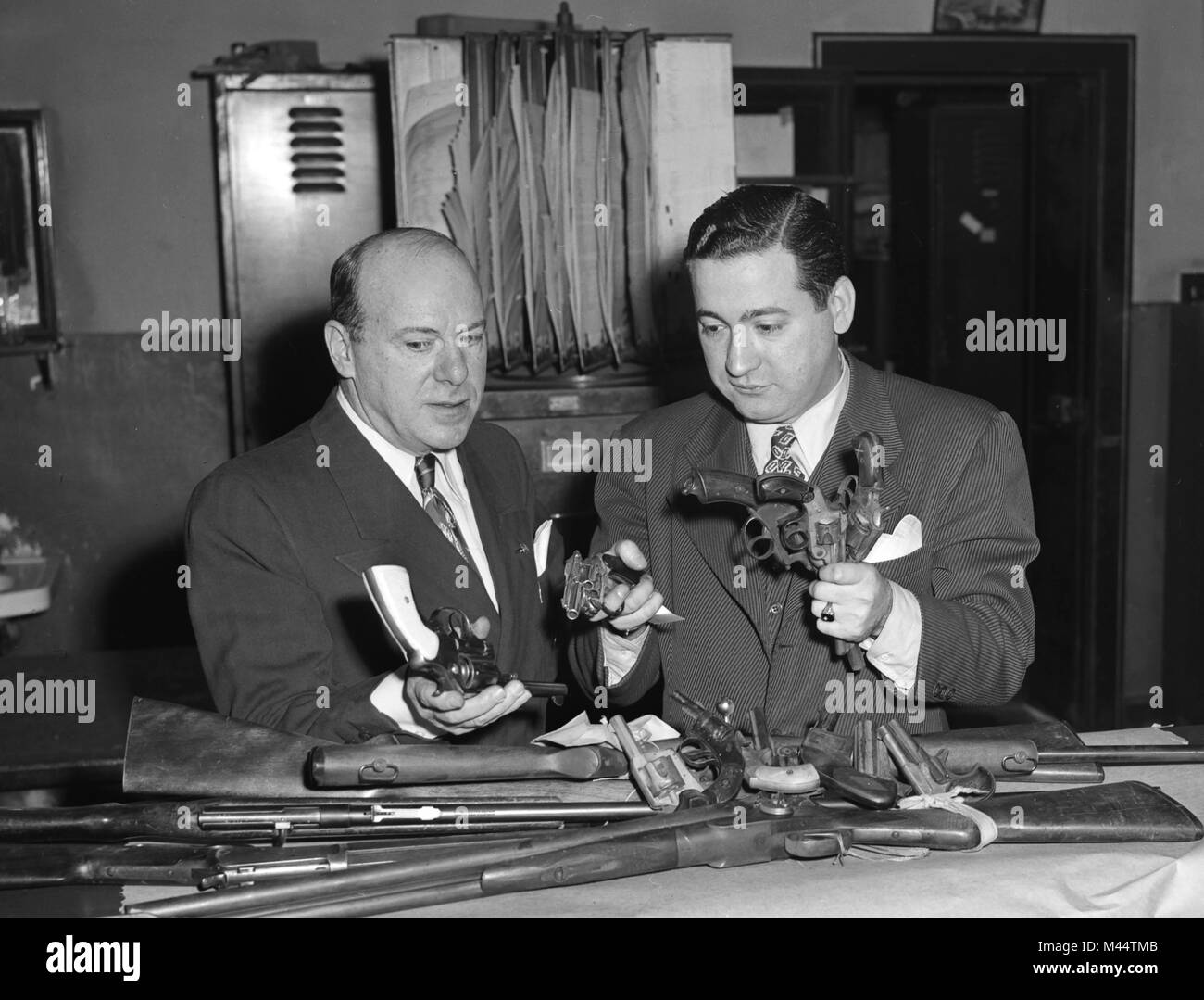 Chicago police display a cache of seized illegal guns, ca. 1955. Stock Photo