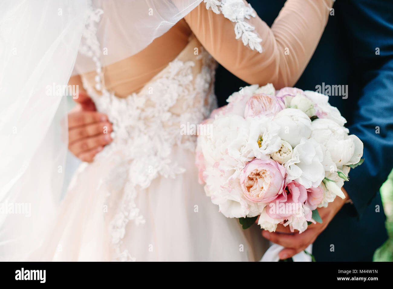Bride and groom holding wedding peony bouquet in your hands. White and ...