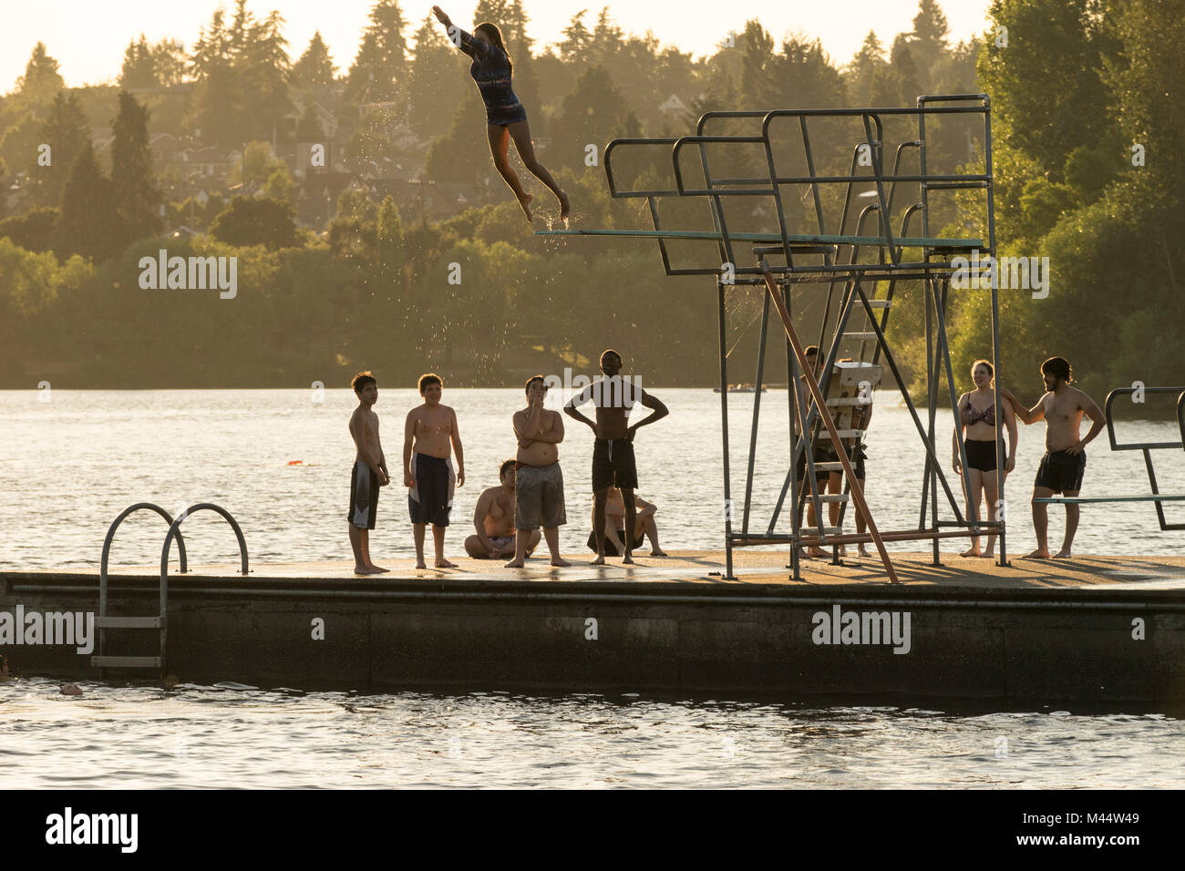 Jumping off of diving board at Green Lake, Seattle, Washington, USA