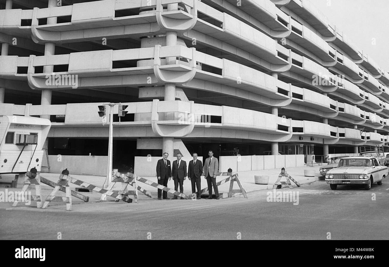 Businessmen proudly stand by a new parking garage in Columbus, Ohio, ca. 1962. File name: Stock Photo