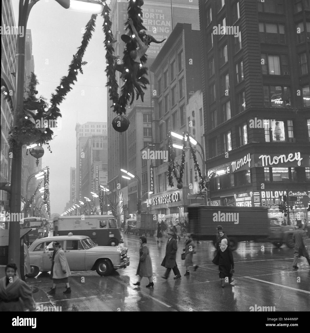 It's a warm and foggy day at the corner of State and Madison in Chicago during Christmas season, ca. 1968. . Stock Photo