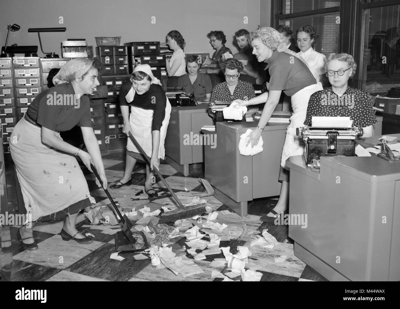 Office workers clean up during a janitors strike in the 1950s. Stock Photo