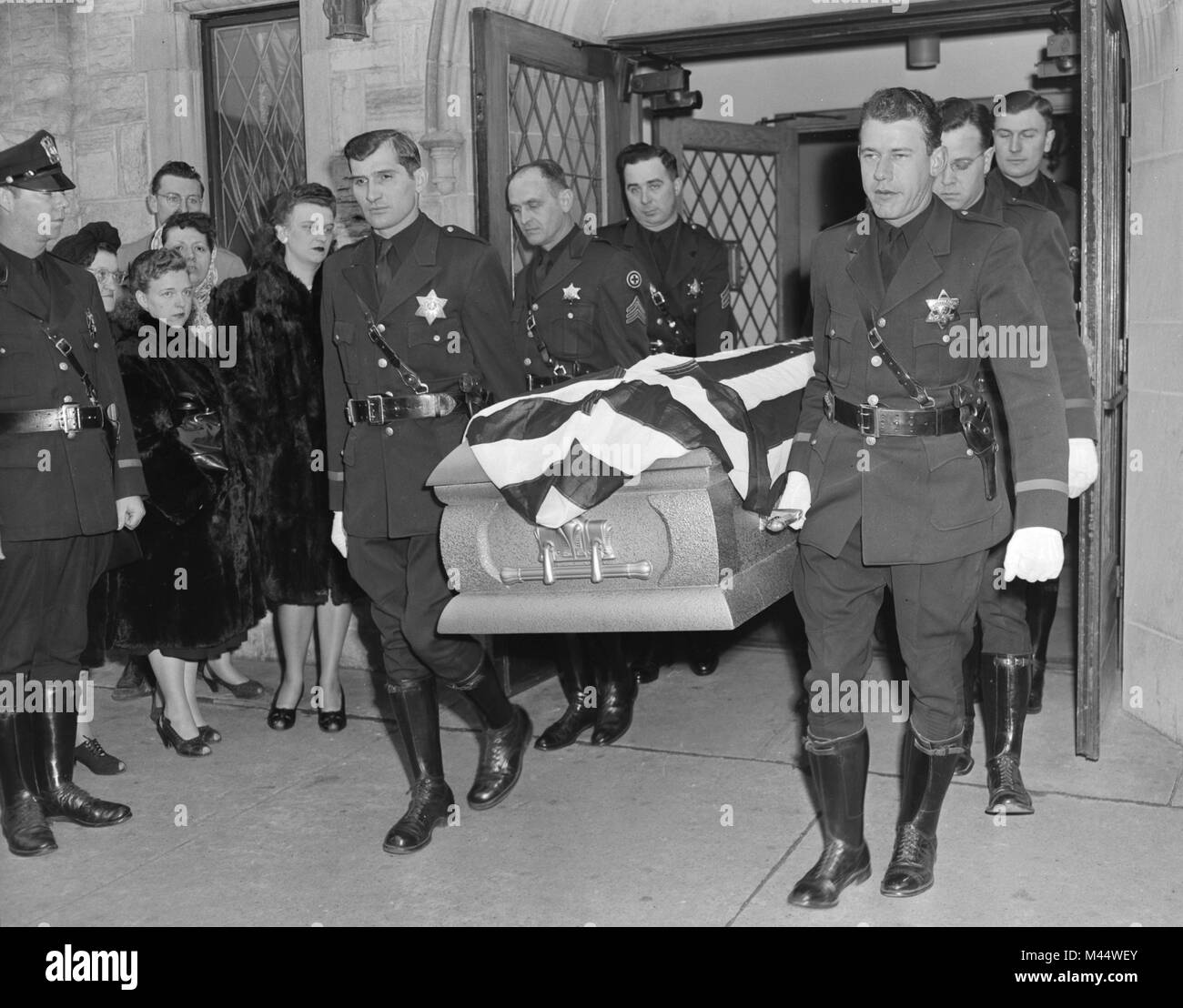 Fellow officers carry the casket of a fallen comrade in Chicago, ca. 1948. Stock Photo