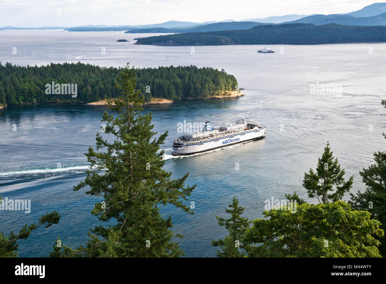 BC Ferry travelling through Active Pass and the Southern Gulf Islands in British Columbia, Canada.  View from Galiano Island. Stock Photo