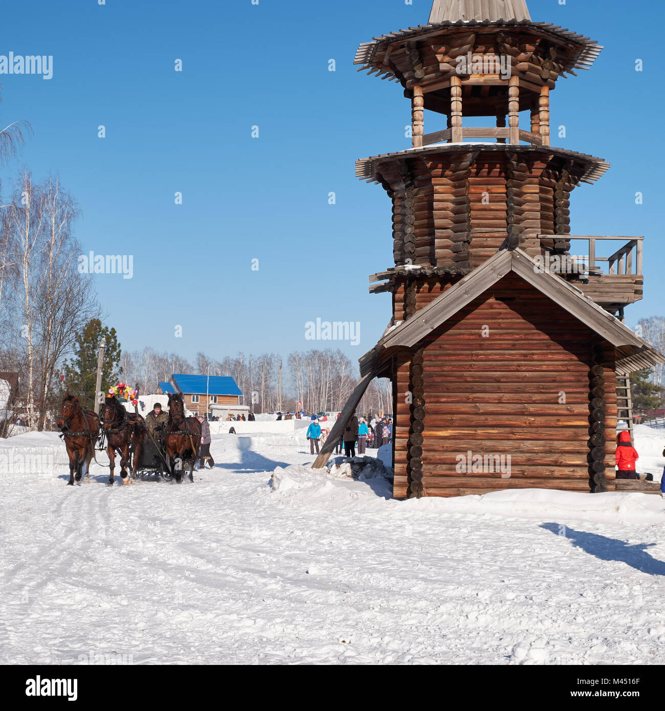 NOVOSIBIRSK, RUSSIA - JANUARY 11, 2018: Troika of horses harnessed to a sleigh.  Slavonic folk  winter festivities Shrovetide. The Church of the Savio Stock Photo